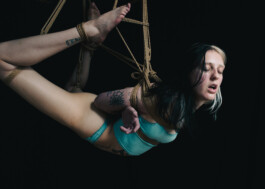 Model suspended in the air, soft colors, intense expression 